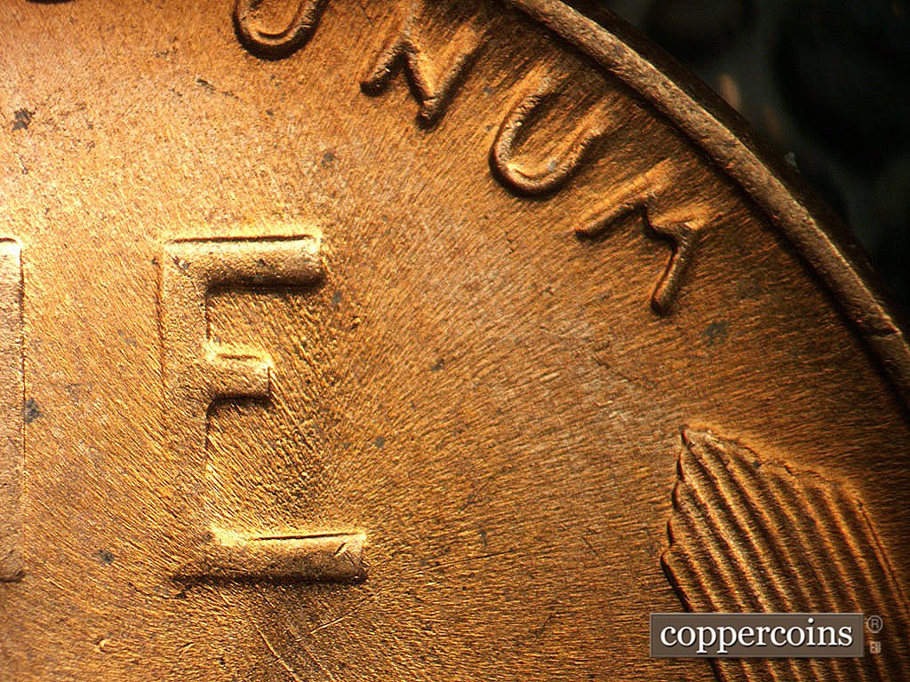 Die-stage C marker on 1956D•1MM•023 showing Light SE die scratches through ONE.