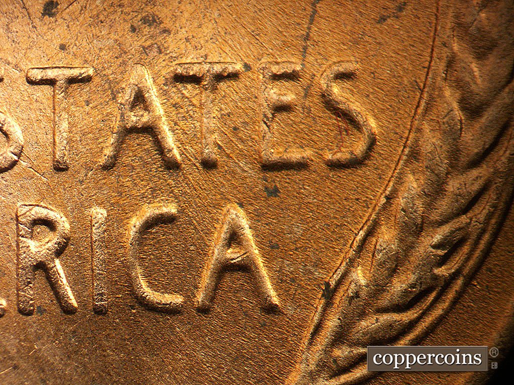 Die-stage C marker on 1956D•1MM•023 showing SE die scratches through STATES and AMERICA.
