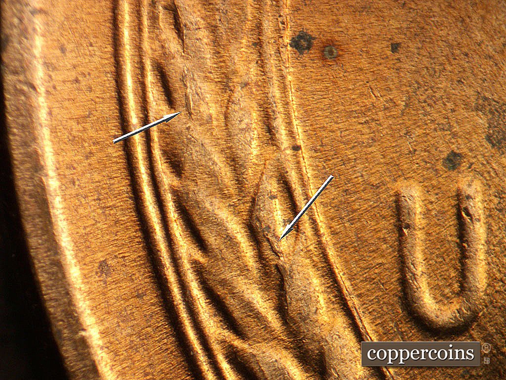 Die-stage C marker on 1956D•1MM•023 showing Die cracking in left wheat stalk.