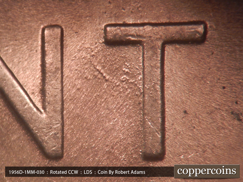 Die-stage C marker on 1956D•1MM•030 showing SE die scratch between NT in CENT.