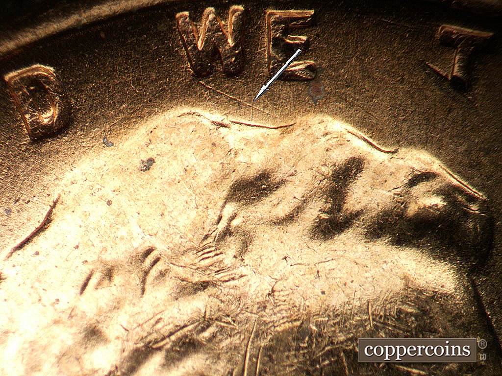 Die-stage B marker on 1956D•1MM•030 showing SE die scratch from bottom of W in WE.