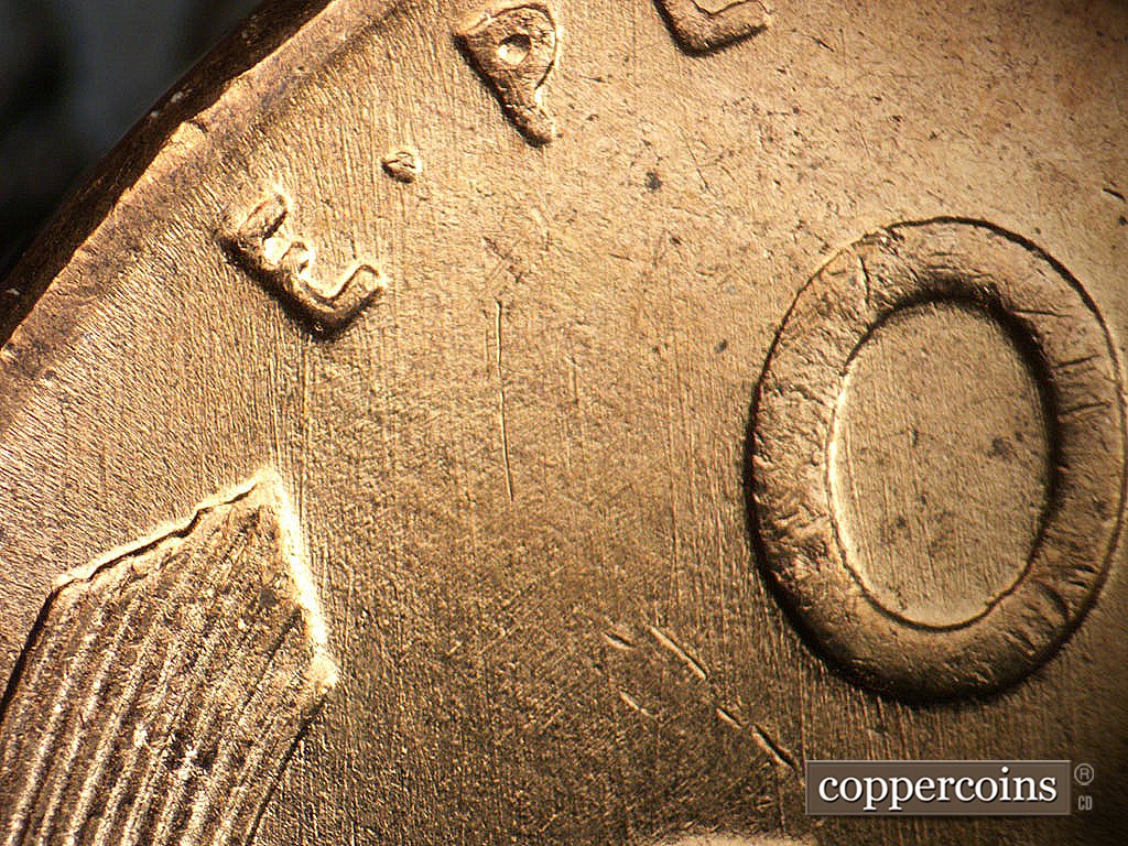 Die-stage B marker on 1956D•1MM•030 showing Generally N/S die scratches through EPU.