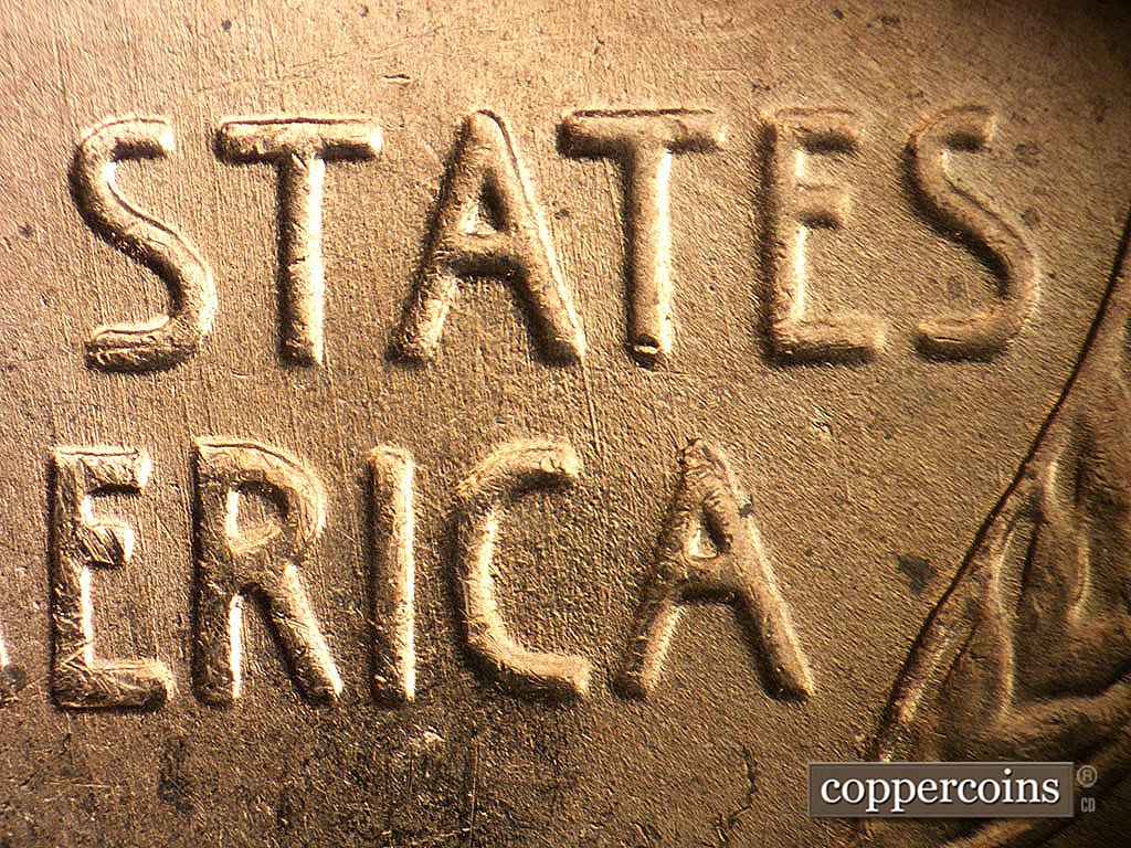 Die-stage B marker on 1956D•1MM•030 showing N/S die scratches through STATES and AMERICA.