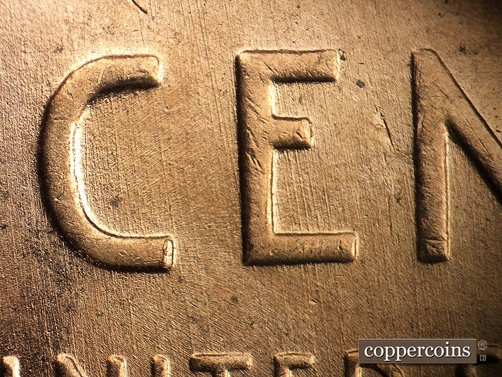 Die-stage B marker on 1956D•1MM•030 showing N/S die scratches through CENT.