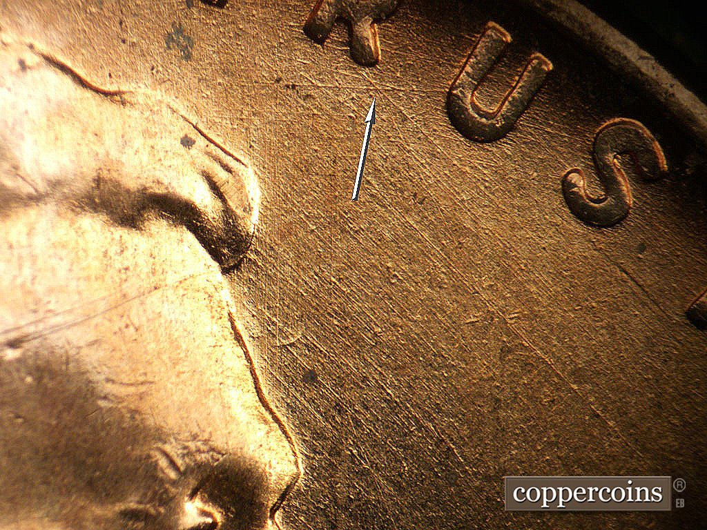 Die-stage A marker on 1956D•1MM•062 showing E/W die scratch from U in TRUST.