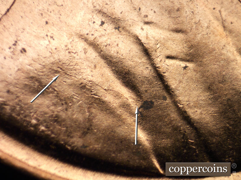 Die-stage B marker on 1956D•1MM•062 showing Die crack across shoulder.