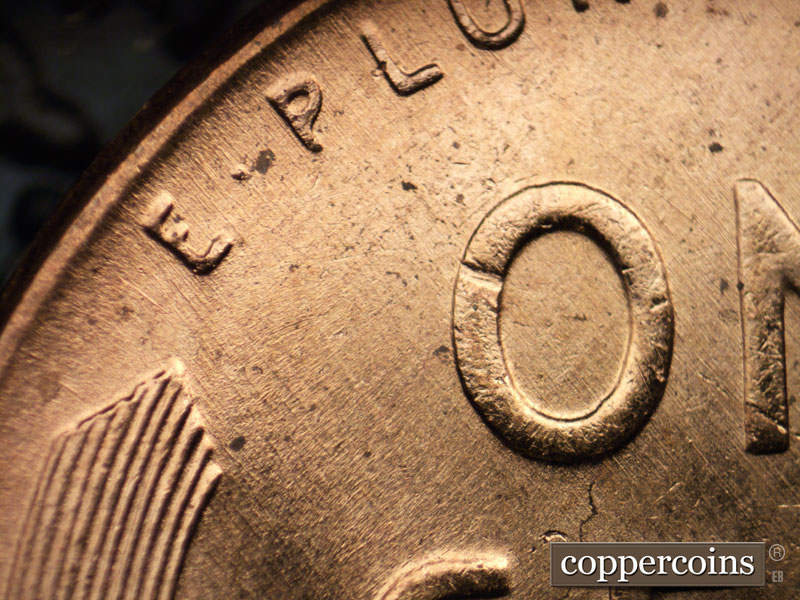 Die-stage B marker on 1956D•1MM•062 showing Light SE die scratches cover top of reverse.