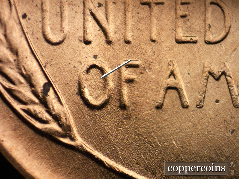 Die-stage B marker on 1956D•1MM•062 showing SE die scratch through O in OF.