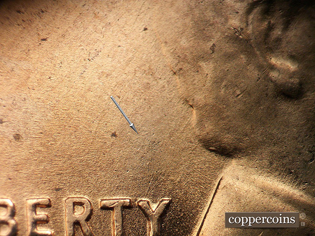 Die-stage B marker on 1956D•1MM•085 showing SW die scratch above T in LIBERTY.