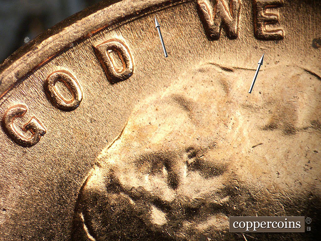 Die-stage B marker on 1956D•1MM•085 showing Concentric gouge between rim and GOD WE, smal SE die gouges under E in WE.