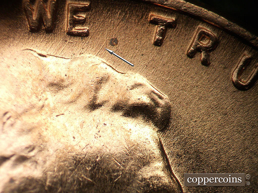 Die-stage B marker on 1956D•1MM•085 showing NE die scratches from top of hair.