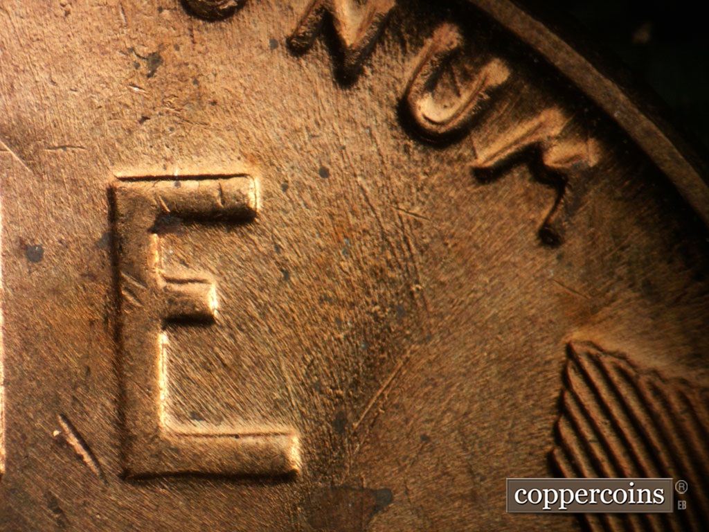 Die-stage B marker on 1956P•1DO•008 showing Die scratches through UNUM.