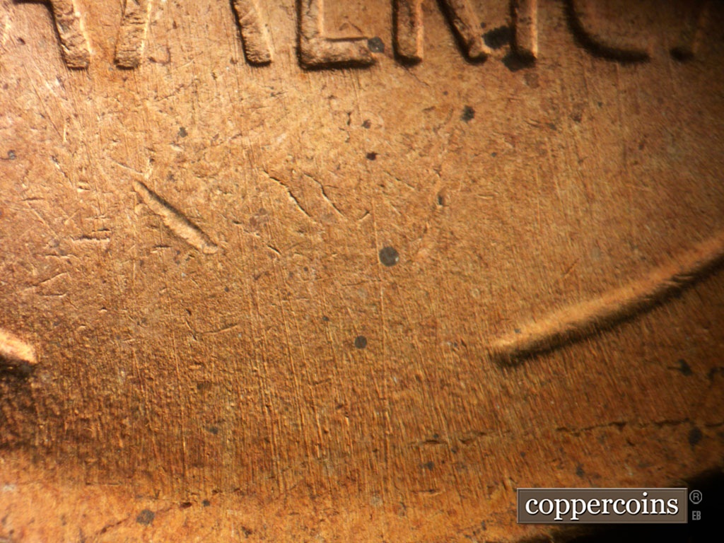 Die-stage B marker on 1956P•1DO•008 showing Light N/S die scratches show in field between wheat stems.
