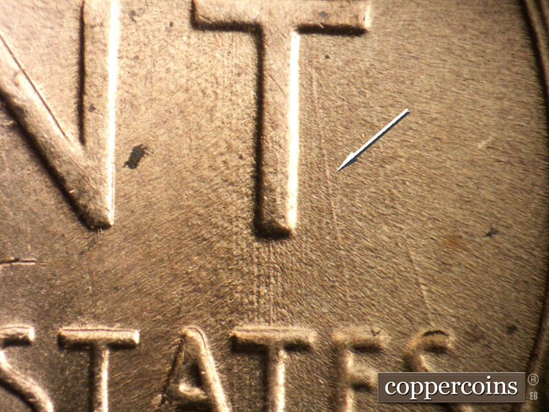 Die-stage B marker on 1957D•1DO•005 (1957 Doubled Die Obverse).