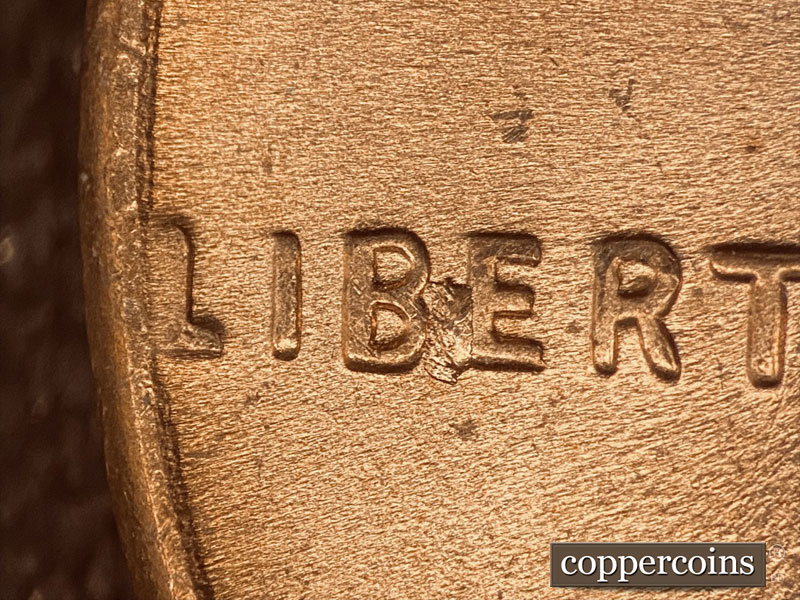 Die-stage C marker on 1957D•1DO•005 (1957 Doubled Die Obverse).