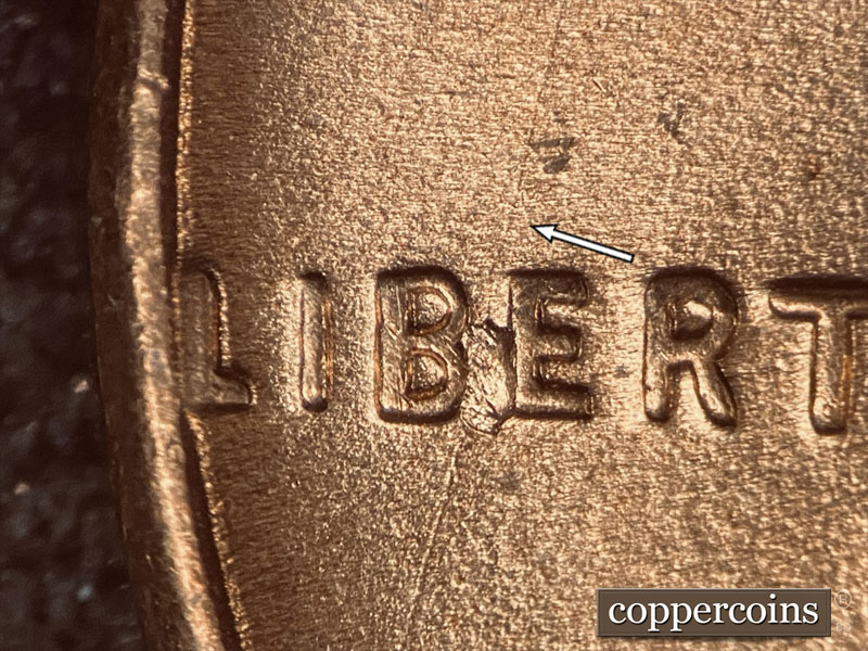 Die-stage C marker on 1957D•1DO•005 (1957 Doubled Die Obverse).