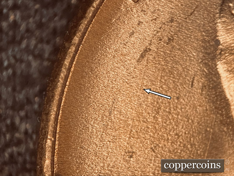 Die-stage C marker on 1957D•1DO•005 (1957 Doubled Die Obverse).