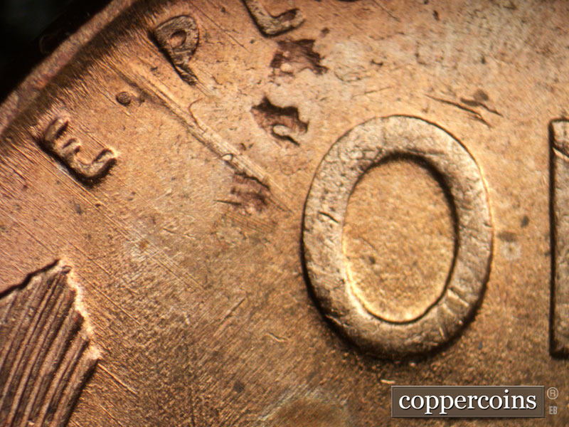 Die-stage A marker on 1957D•1DO•006 (1957 Doubled Die Obverse).