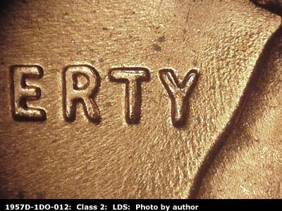 Die-stage C marker on 1957D•1DO•012 (1957 Doubled Die Obverse).