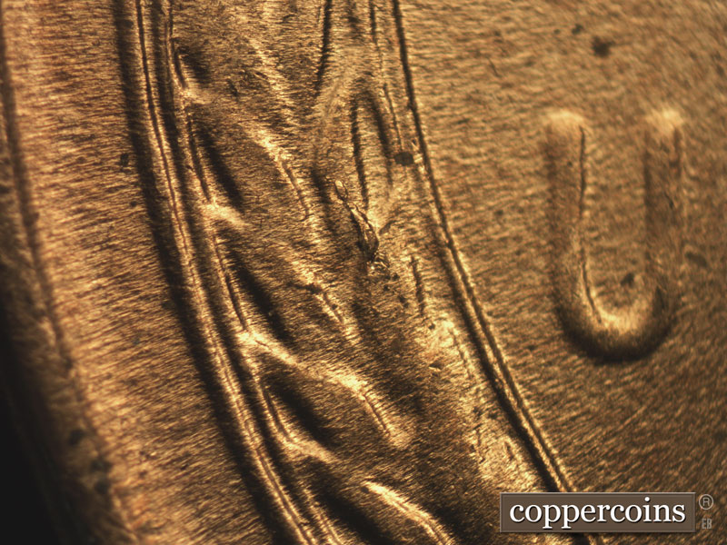 Die-stage C marker on 1957D•1DO•014 (1957 Doubled Die Obverse).