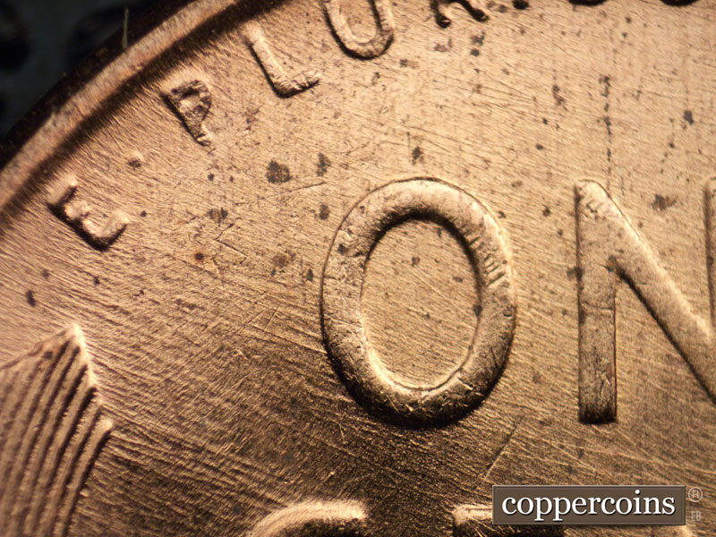Die-stage B marker on 1957D•1DO•023 (1957 Doubled Die Obverse).