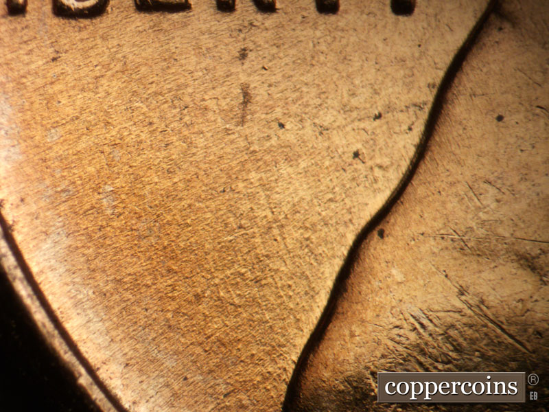 Die-stage B marker on 1957D•1DO•031 (1957 Doubled Die Obverse).
