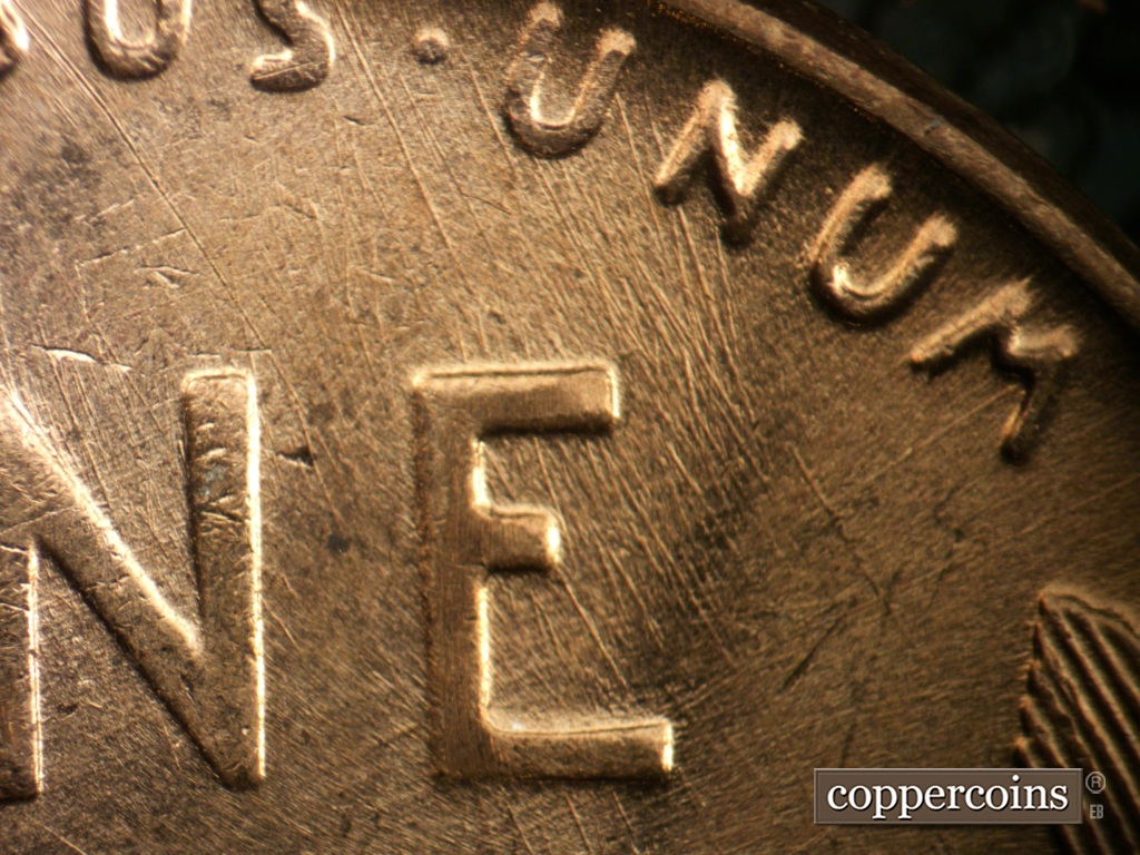 Die-stage B marker on 1957D•1DO•038 showing SSE die scratches from UNUM through E in ONE.