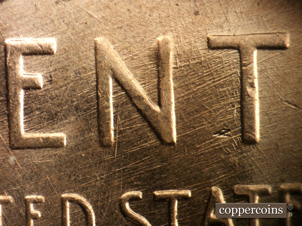 Die-stage B marker on 1957D•1DO•038 showing ENE die scratches through ENT in CENT.