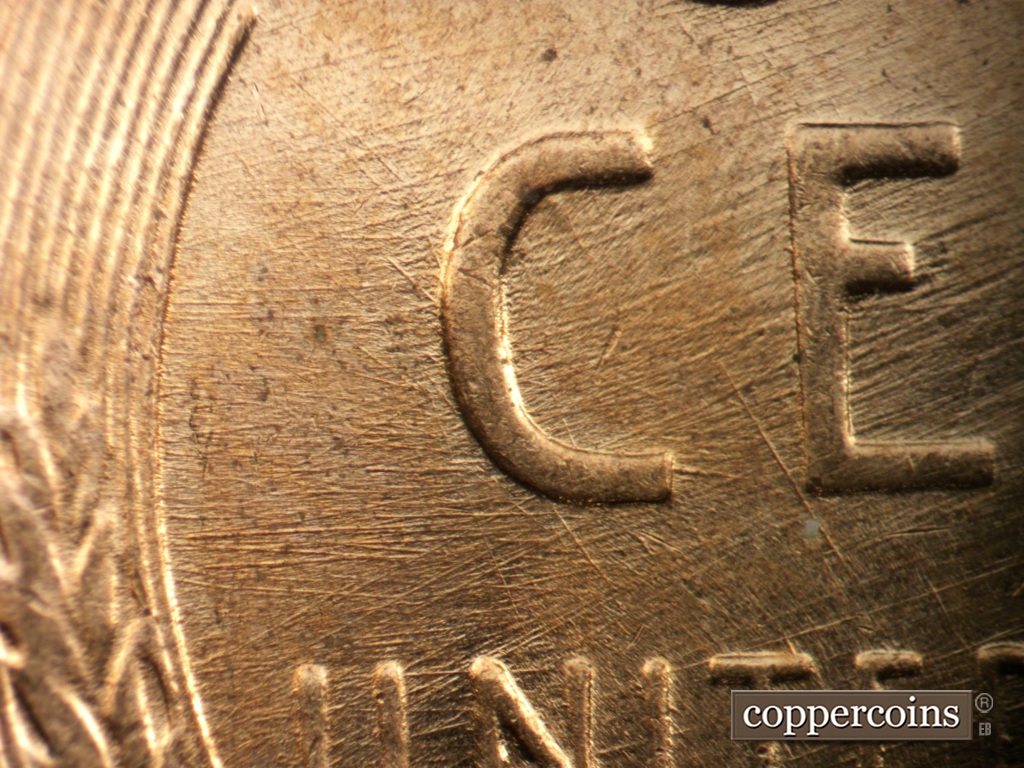 Die-stage B marker on 1957D•1DO•038 showing E/W die scratches from lefte wheat stalk to C in CENT. ENE die scratches from inside C of CENT through E in CENT.