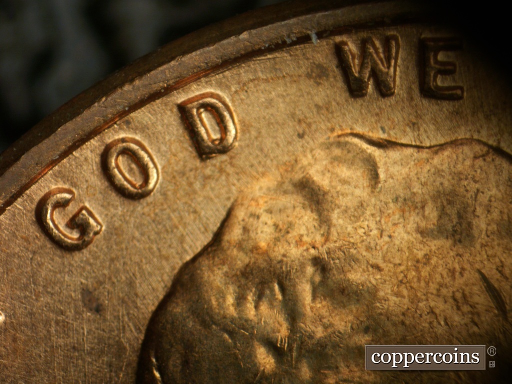 Die-stage A marker on 1957D•1DO•040 showing Concentric scratches near rim, between D in GOD and W in WE.