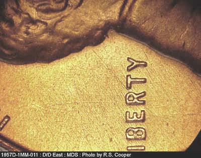 Die-stage B marker on 1957D•1MM•011 (1957 Repunched Mint Mark).
