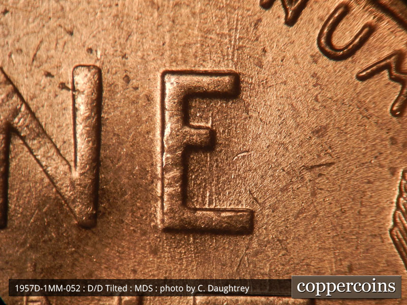 Die-stage B marker on 1957D•1MM•052 (1957 Repunched Mint Mark).