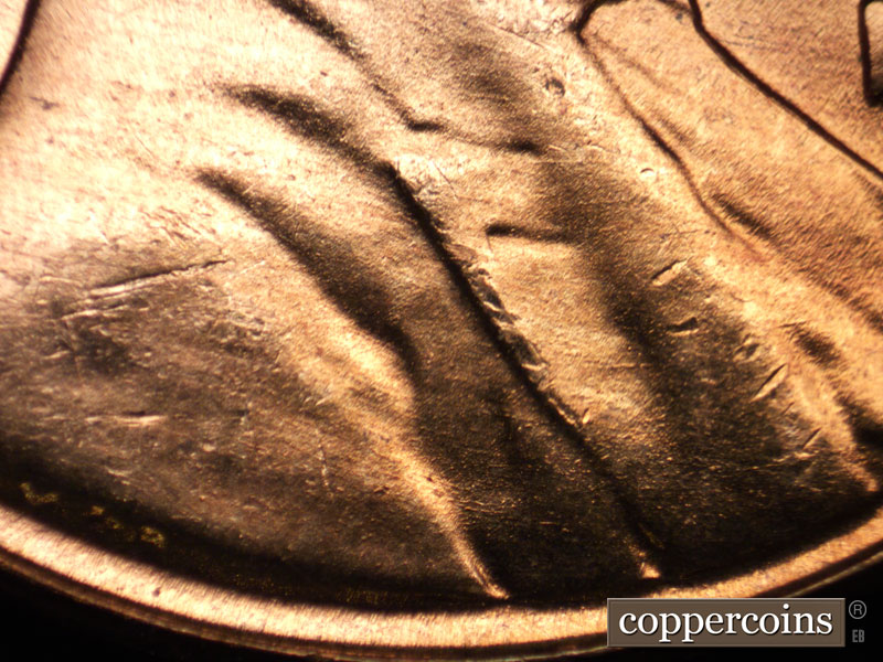 Die-stage B marker on 1957D•1MM•077 (1957 Repunched Mint Mark).