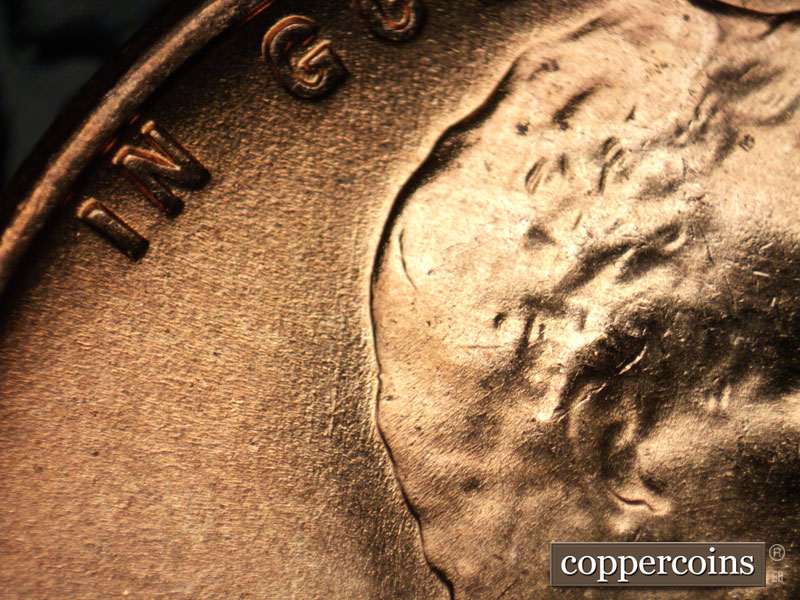 Die-stage B marker on 1957D•1MM•077 (1957 Repunched Mint Mark).