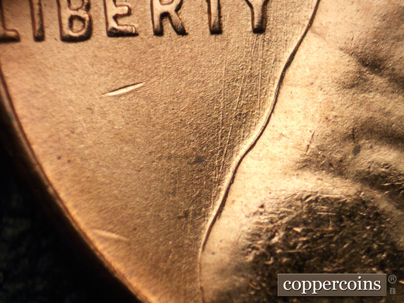 Die-stage B marker on 1957D•1MM•082 (1957 Repunched Mint Mark).