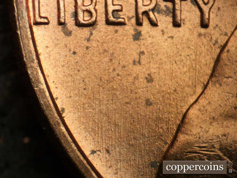Die-stage B marker on 1957D•1MM•093 showing N/S die scratches in field below LIBERTY.