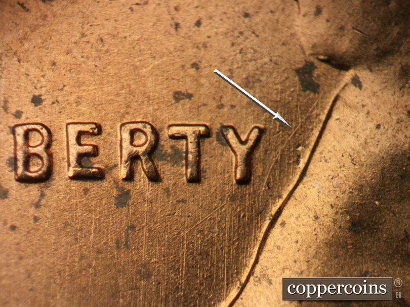 Die-stage B marker on 1957D•1MM•093 showing Curved die scratch from back of neck. N/S die scratches through LIBERTY.