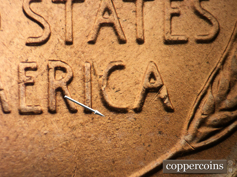 Die-stage B marker on 1957D•1MM•093 showing SW die scratch through bottom of C in AMERICA.
