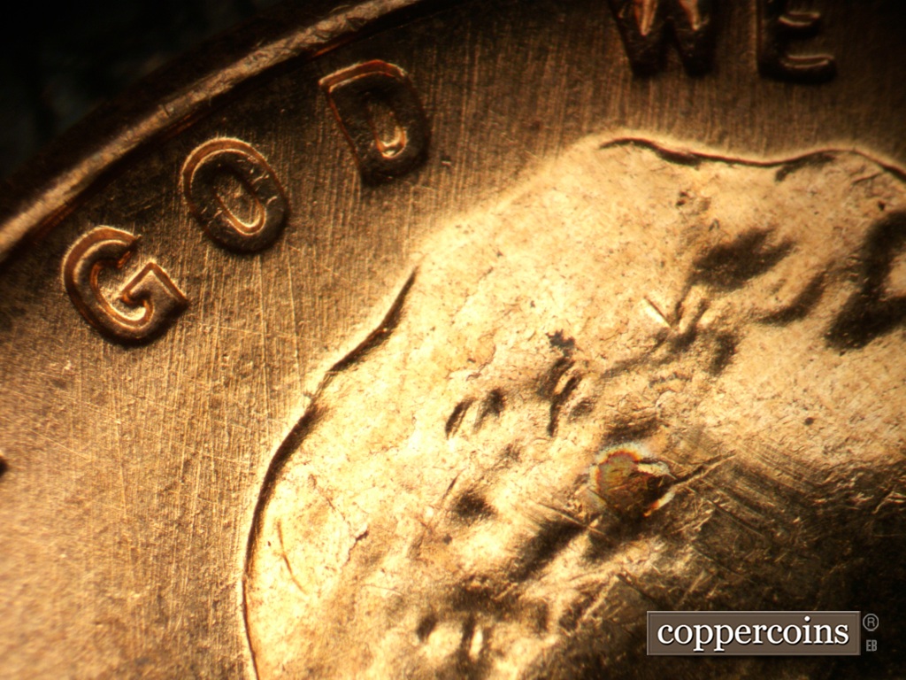 Die-stage A marker on 1957D•1MM•093 showing N/S die scratch through IN GOD WE.