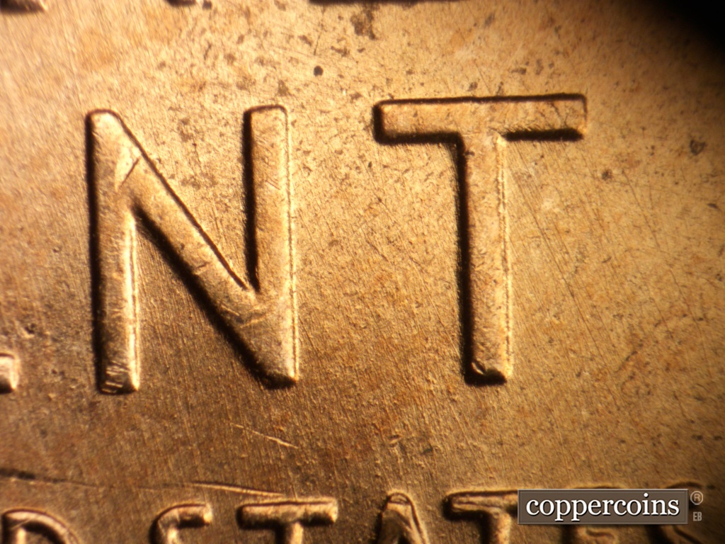 Die-stage A marker on 1957D•1MM•093 showing NNW die scratches through NT in CENT.