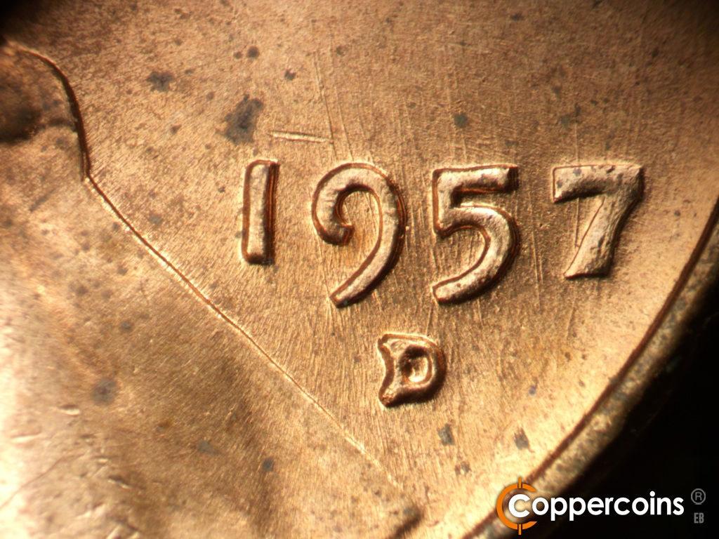 Die-stage B marker on 1957D•1MM•104 showing Die scratches through date.