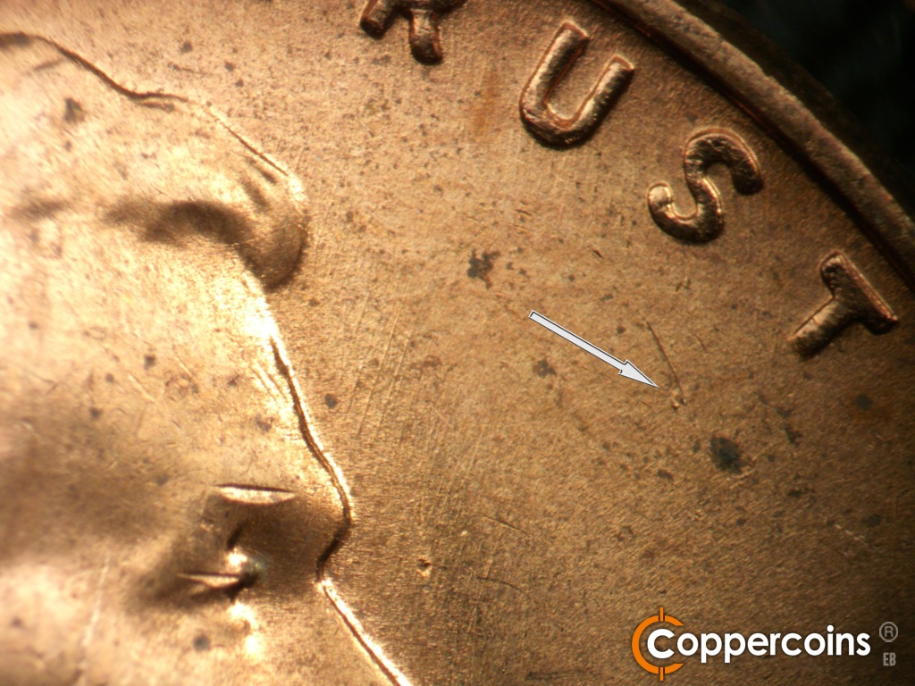 Die-stage B marker on 1957D•1MM•104 showing Die dot under ST in TRUST.