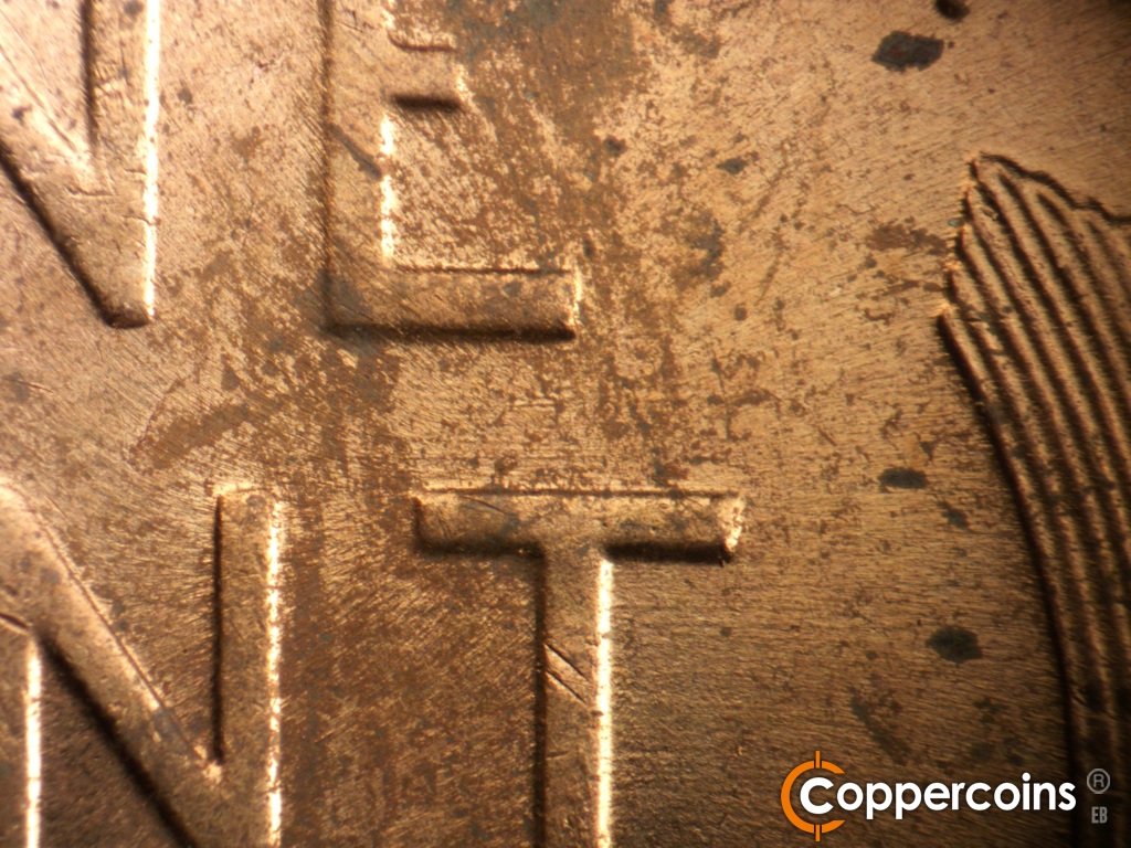 Die-stage B marker on 1957D•1MM•104 showing E/W die scratches through E in ONE and T in CENT.