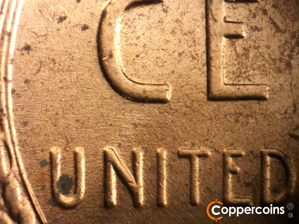 Die-stage B marker on 1957D•1MM•104 showing Light E/W die scratches between C in CENT and N in UNITED.