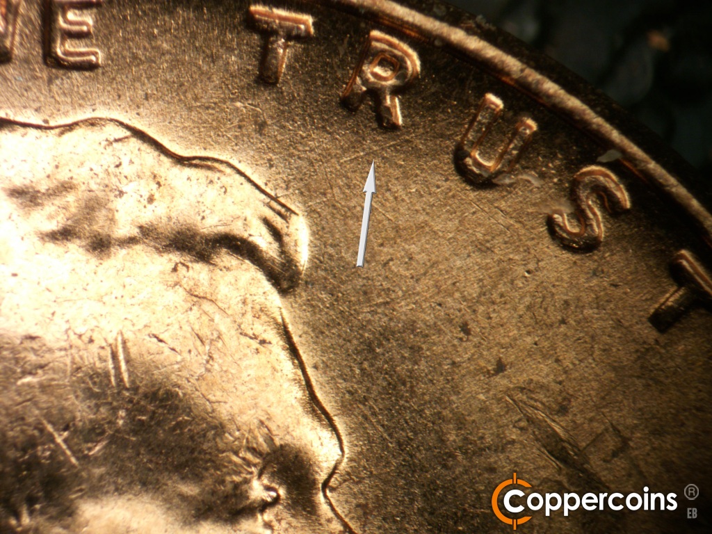 Die-stage B marker on 1957D•1MM•105 showing Die scratches form an X under R in TRUST.