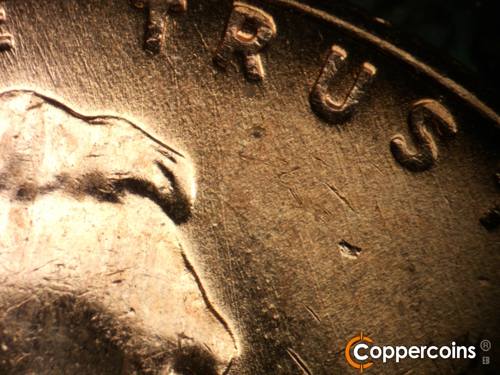 Die-stage B marker on 1957D•1MM•107 showing SE die scratches under TRUST.