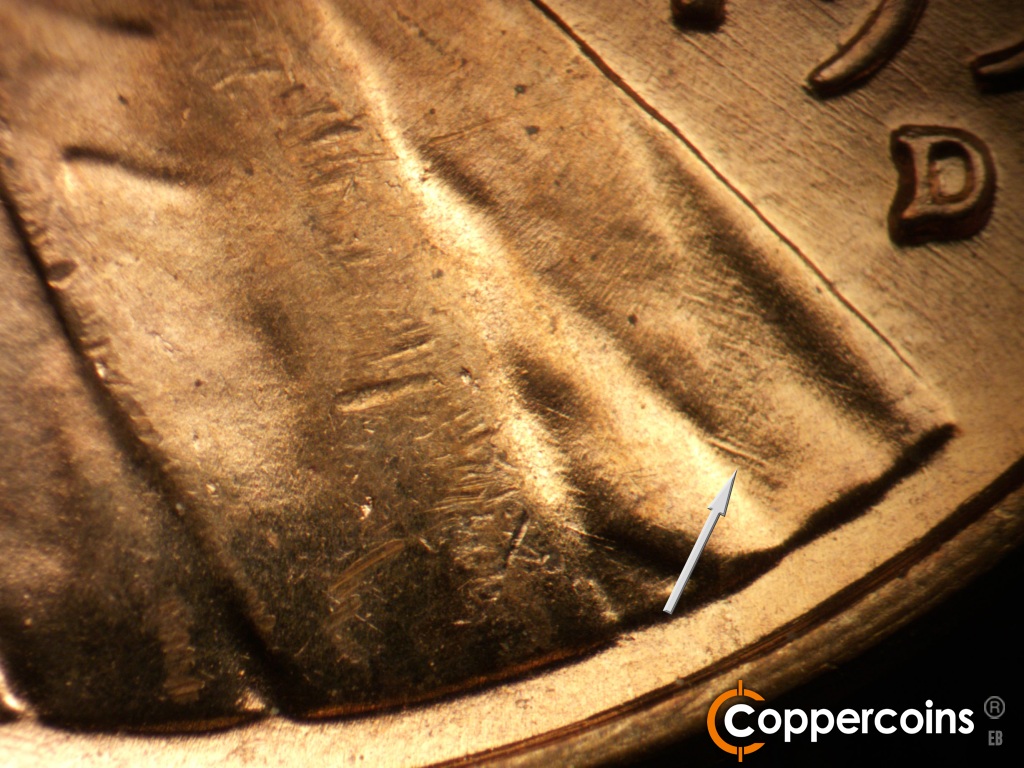 Die-stage B marker on 1957D•1MM•109 showing SE die scratch in lapel.