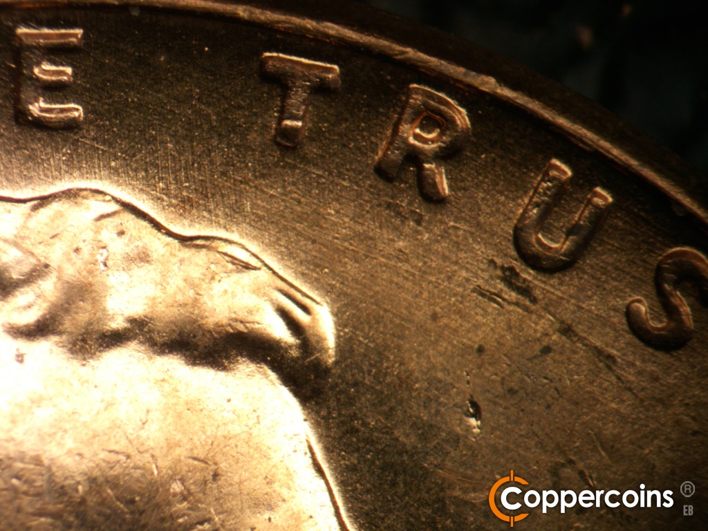 Die-stage B marker on 1957D•1MM•109 showing Light SE die scratches in field under TRUST.