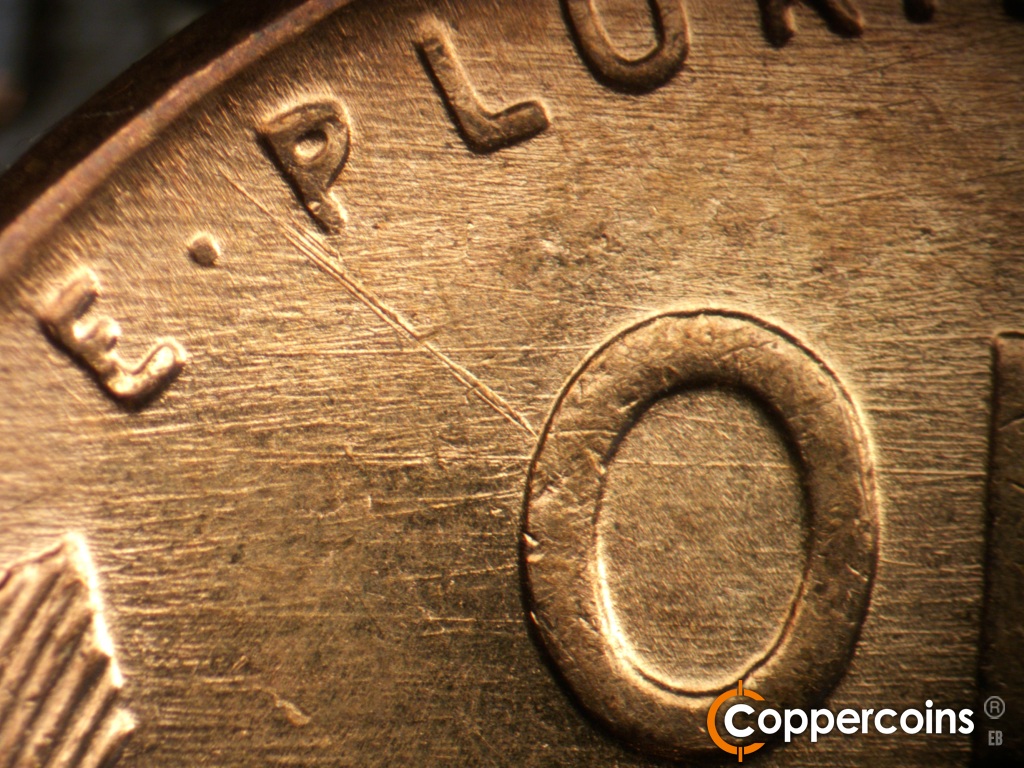 Die-stage B marker on 1957D•1MM•109 showing Die scratches including a heavy SE die scratch from rim to O in ONE.