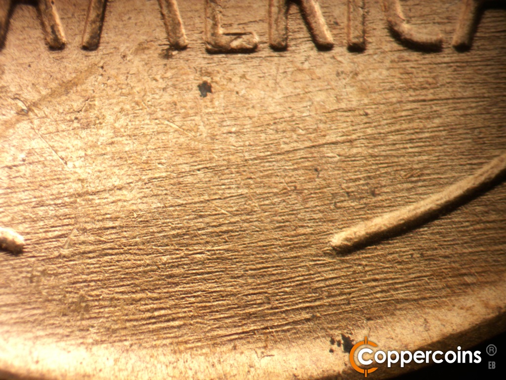 Die-stage B marker on 1957D•1MM•109 showing Die scratches cover lower center of reverse.